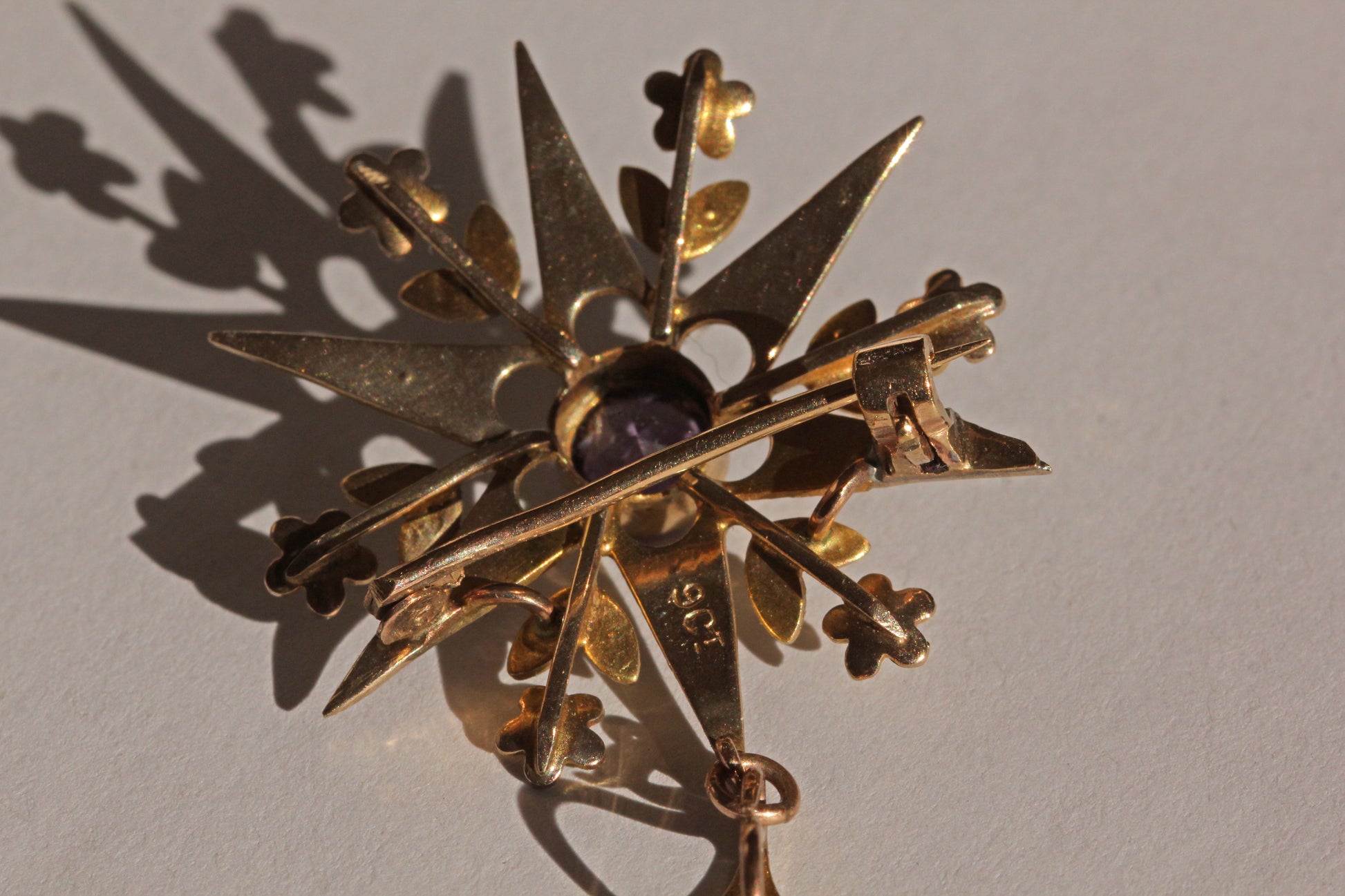Back view of antique star brooch pendant showing clasp and bail
