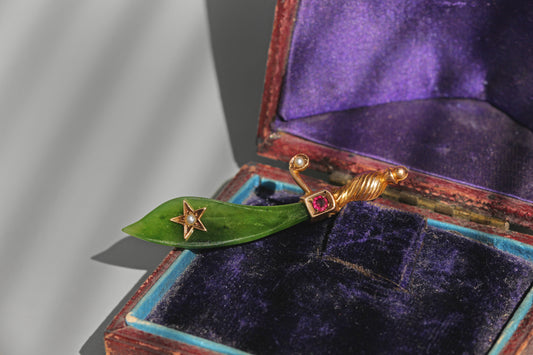 Antique Victorian nephrite jade scimitar brooch in 9 carat gold with ruby and pearl detail
