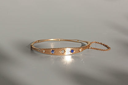 Antique hinged bangle with safety chain and oval shape
