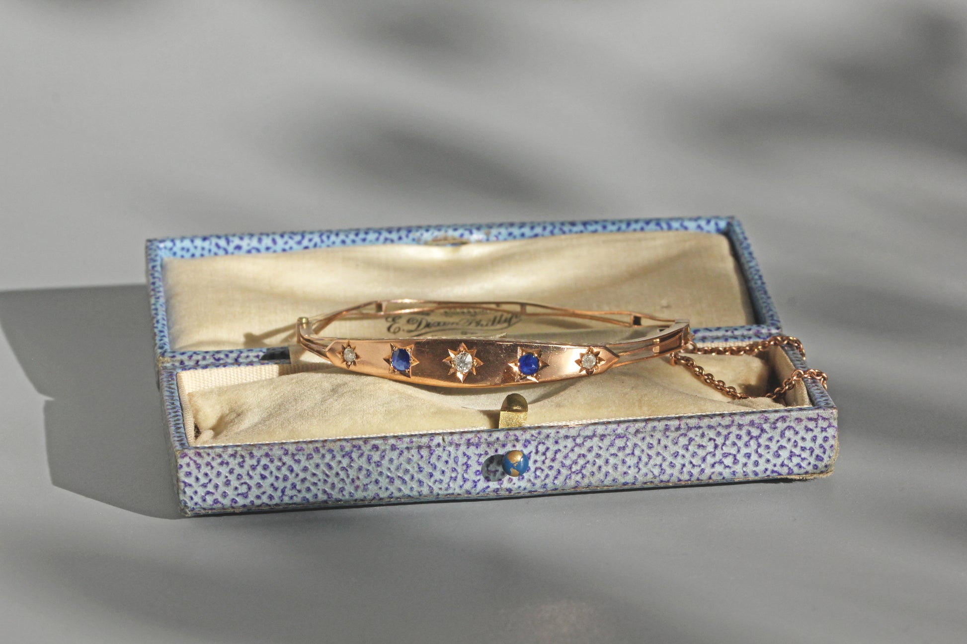 Close up of old cut diamonds and sapphire star settings
