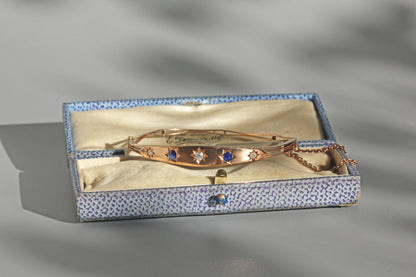 Close up of old cut diamonds and sapphire star settings
