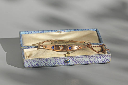 Close up of old cut diamonds and sapphire star settings
