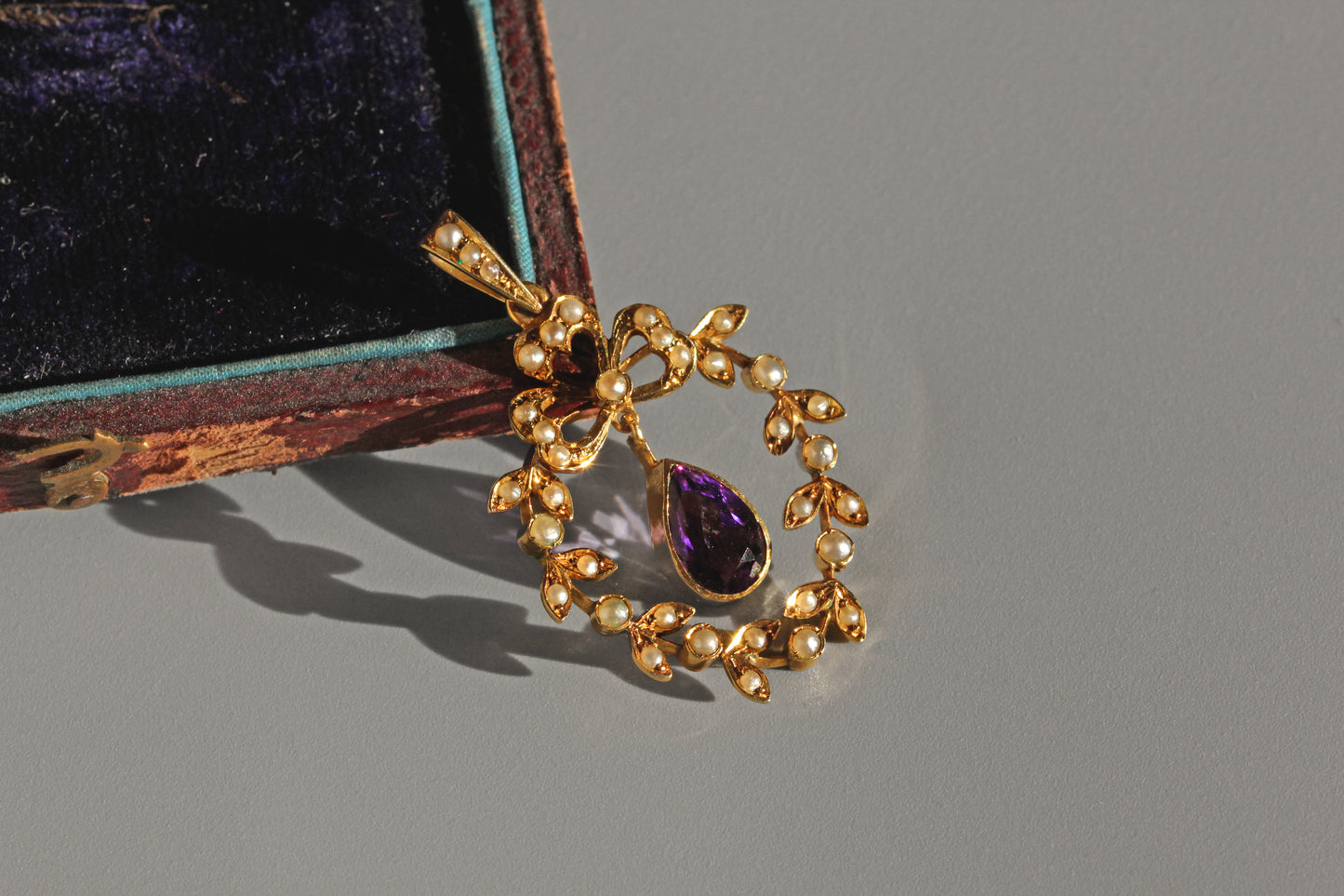 Victorian gold pendant with clover motif and pearl detailing
