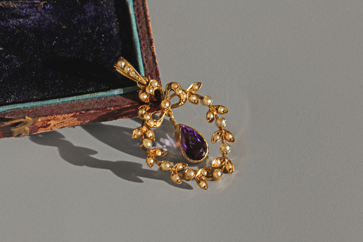 Victorian gold pendant with clover motif and pearl detailing
