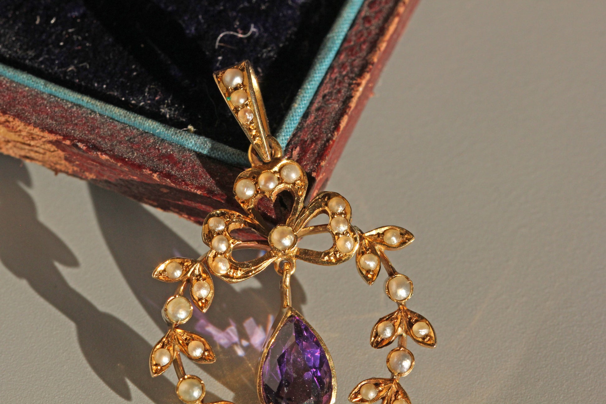 Antique amethyst pendant with openwork garland design
