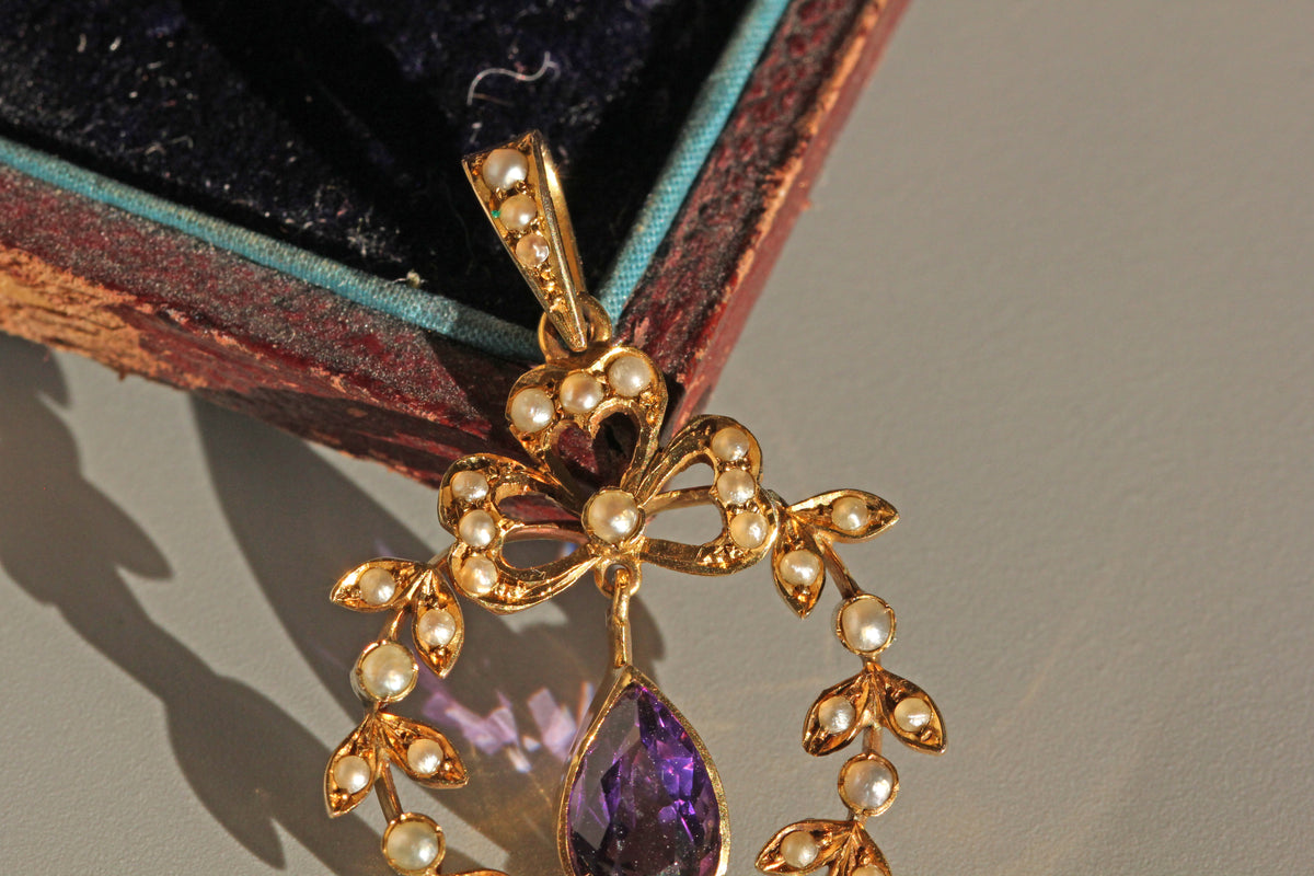 Antique amethyst pendant with openwork garland design
