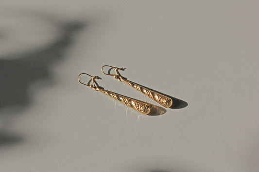Vintage gold drop earrings with milgrain and swirl decoration
