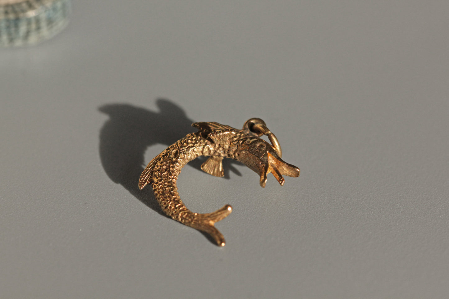 Detailed vintage fish charm with open mouth and fin detail