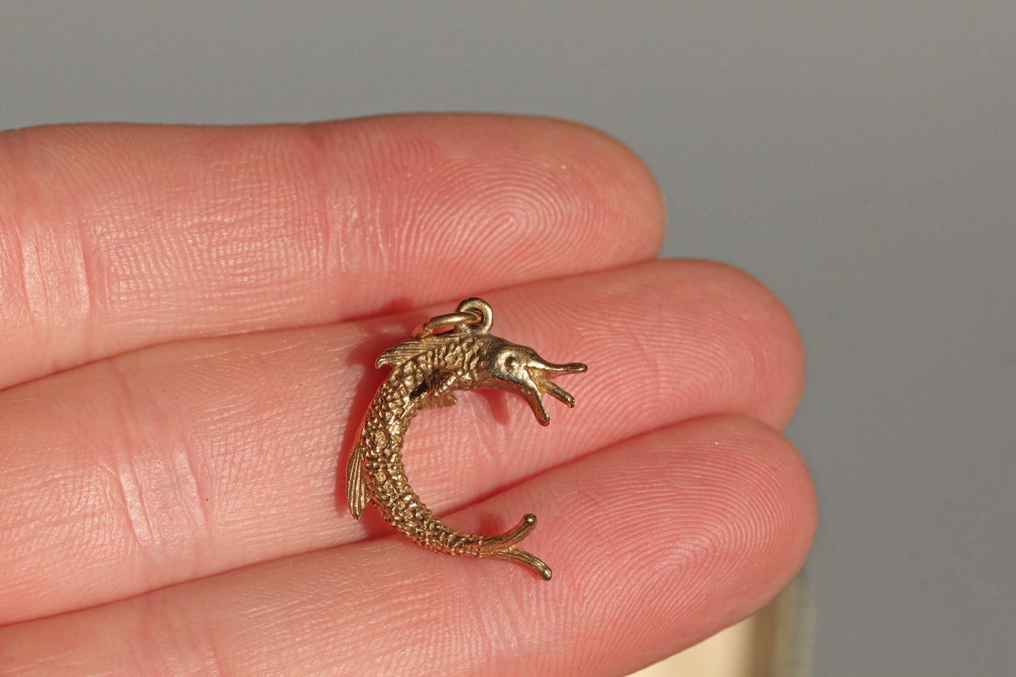 Vintage gold pike fish charm in 9 carat gold on hand