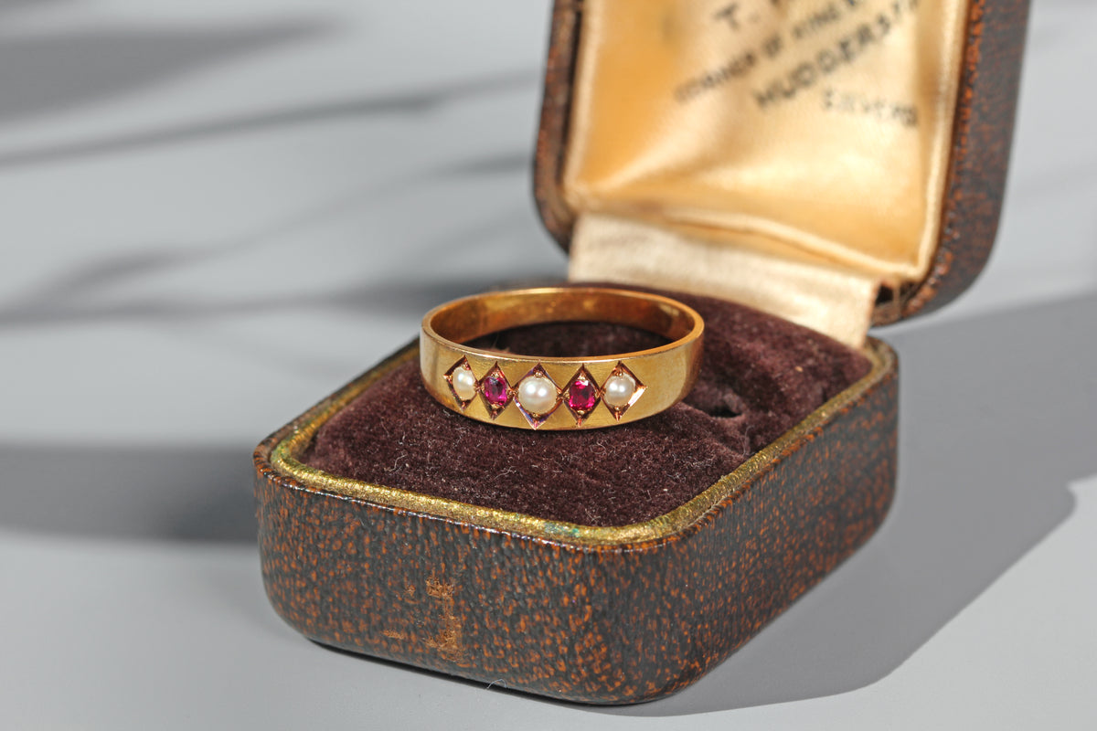 Antique ruby and pearl band ring in 18 carat gold on antique ring box
