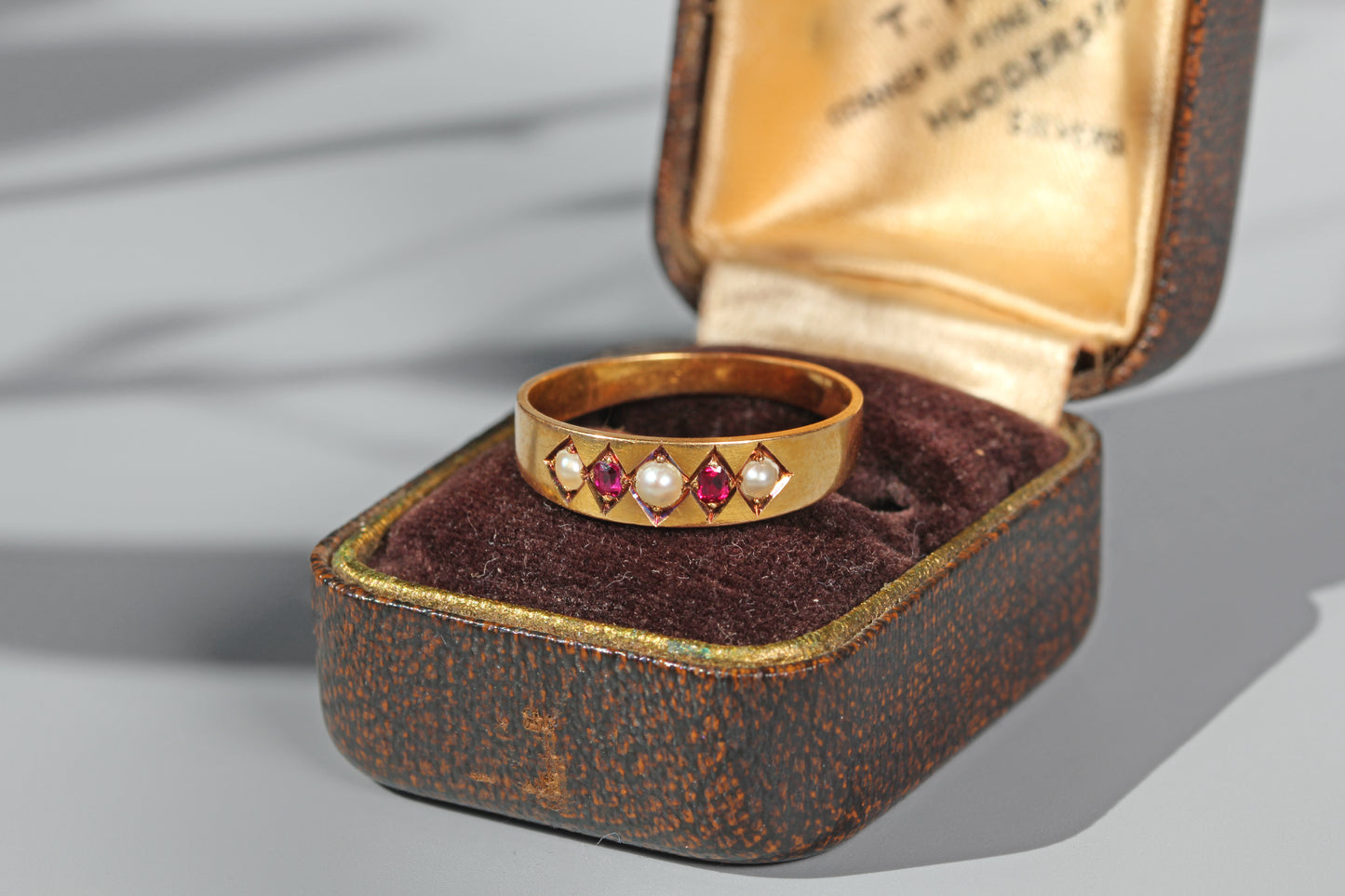 Antique ruby and pearl band ring in 18 carat gold on antique ring box

