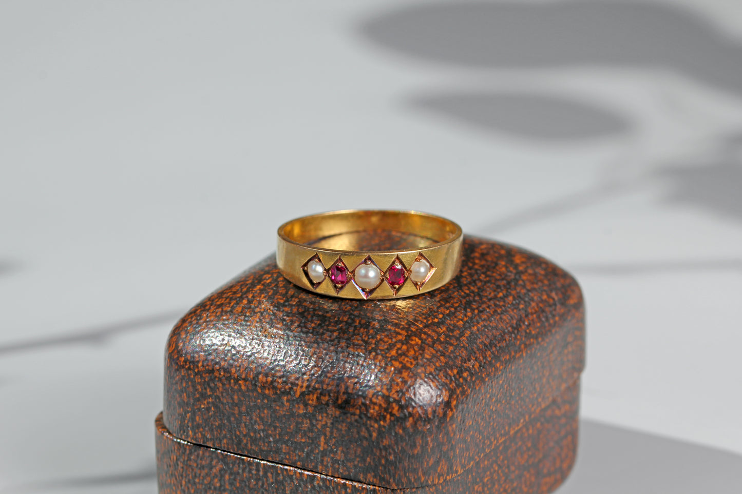 Antique gold band ring with rubies and pearls

