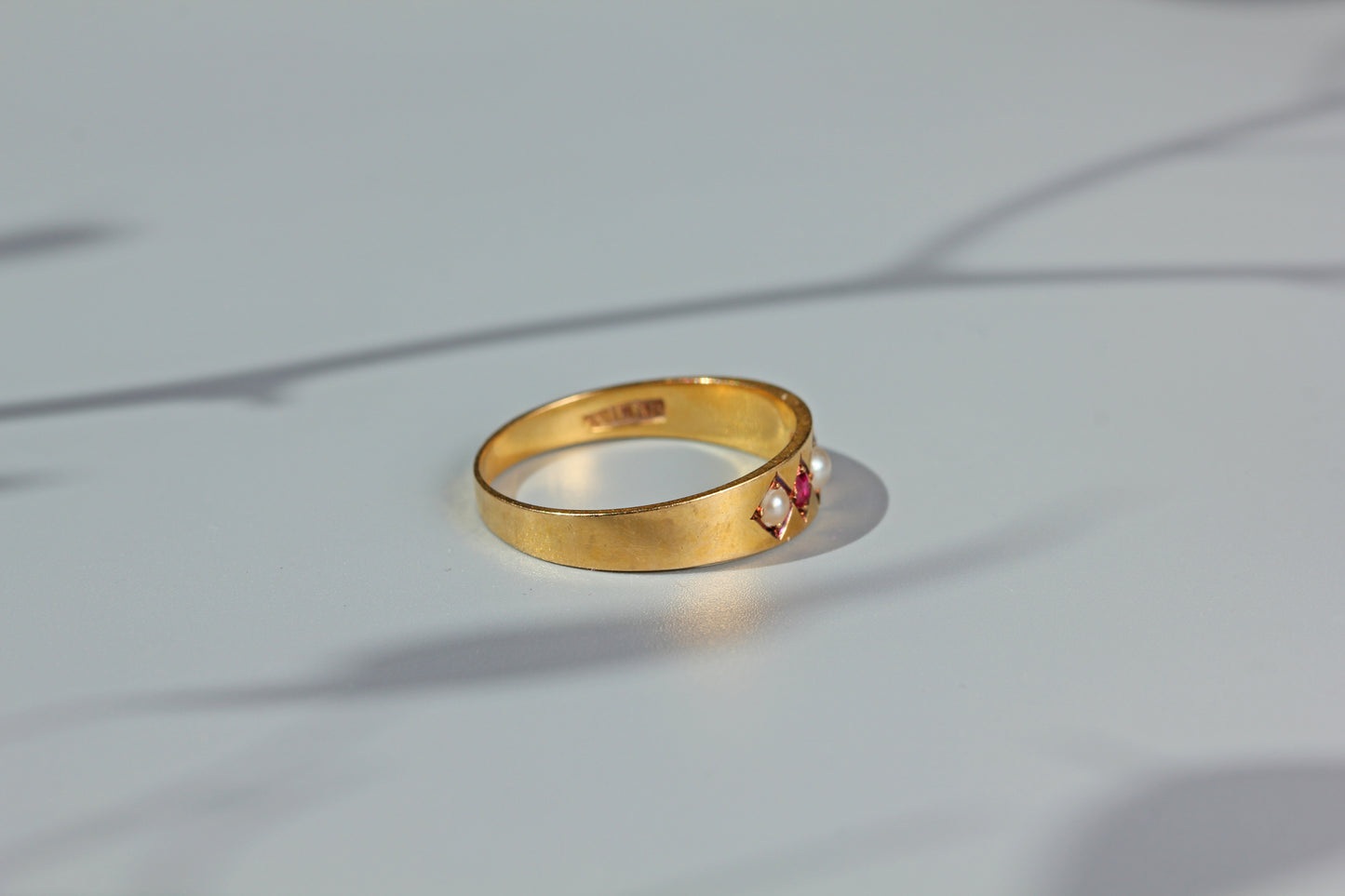 Antique ruby and pearl band ring, in 18 carat gold
