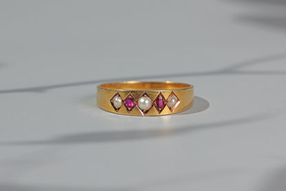 Antique ruby and pearl band ring, in 18 carat gold