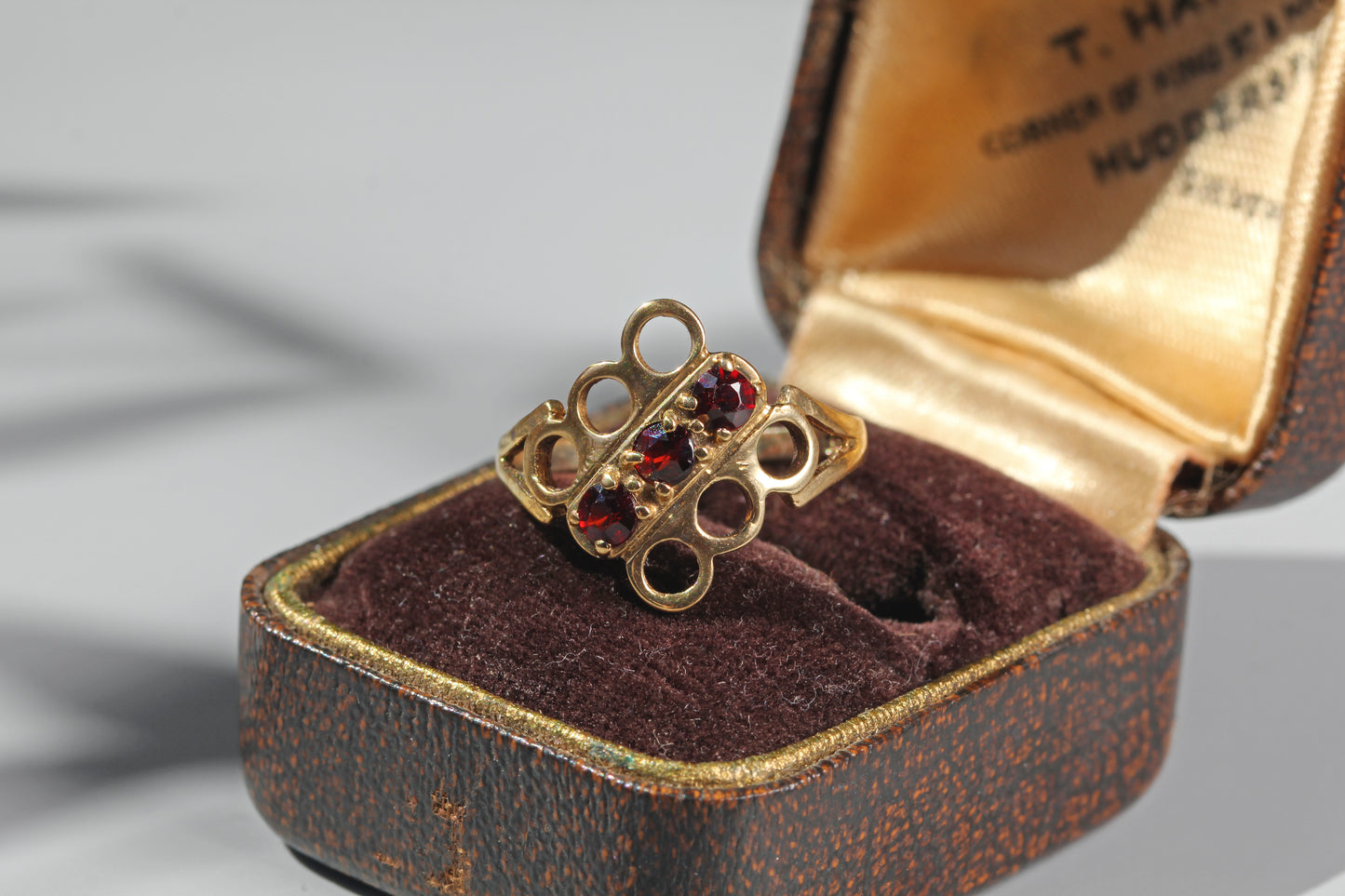 Vintage garnet trilogy ring in 9ct gold on antique ring box
