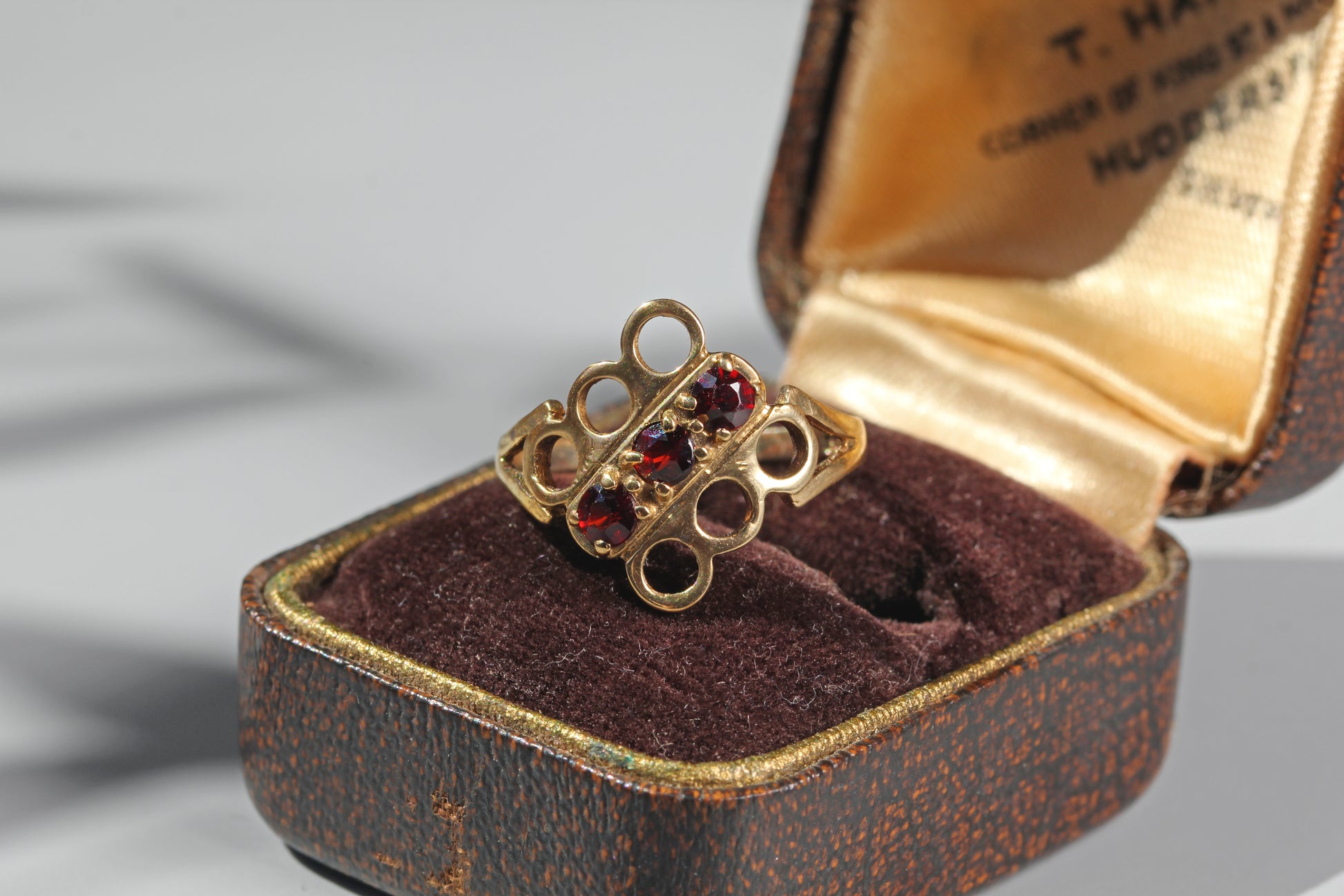 Vintage garnet trilogy ring in 9ct gold on antique ring box