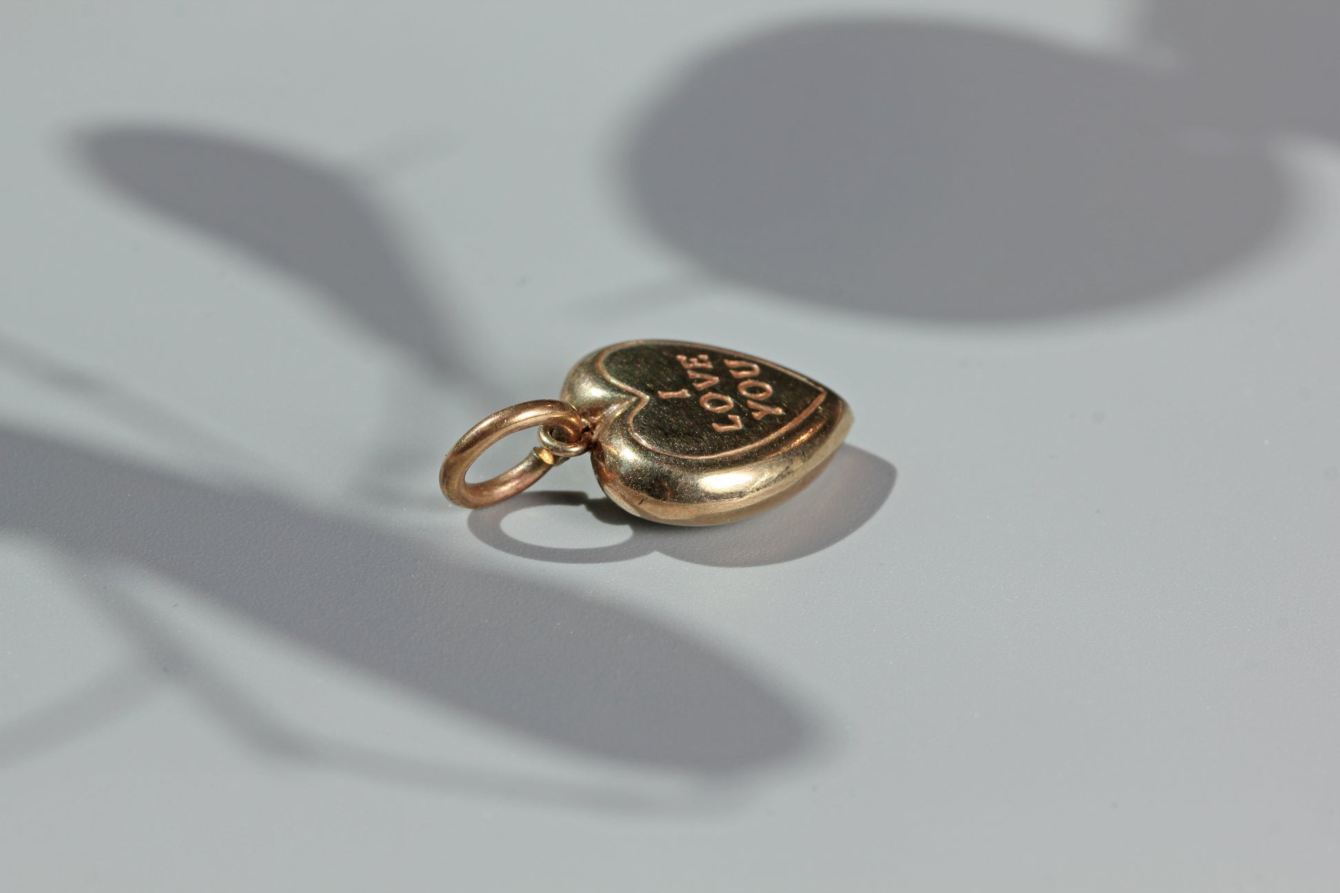 Close up vintage I love you gold heart charm
