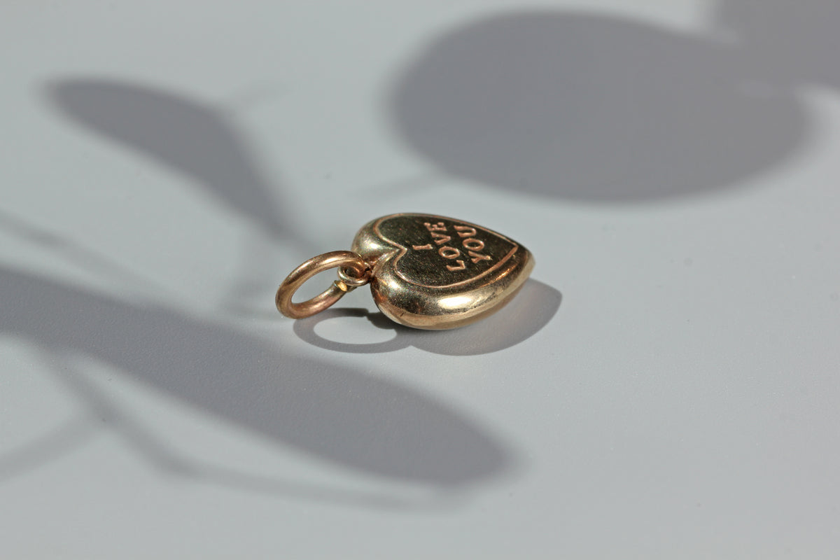 Close up vintage I love you gold heart charm
