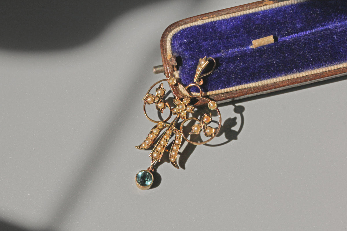 Antique victorian seed pearl and aquamarine pendant in 9 carat gold on blue velvet jewellery box