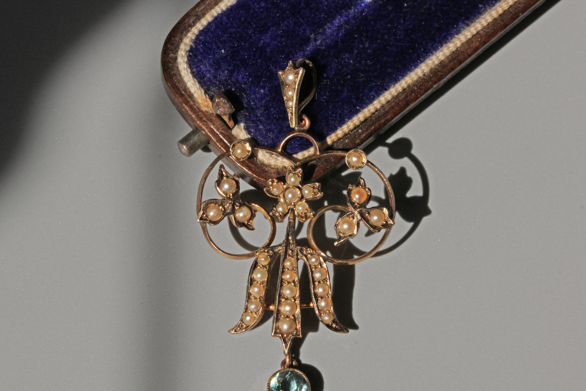 Antique Victorian seed pearl and aquamarine pendant in 9 carat gold close up