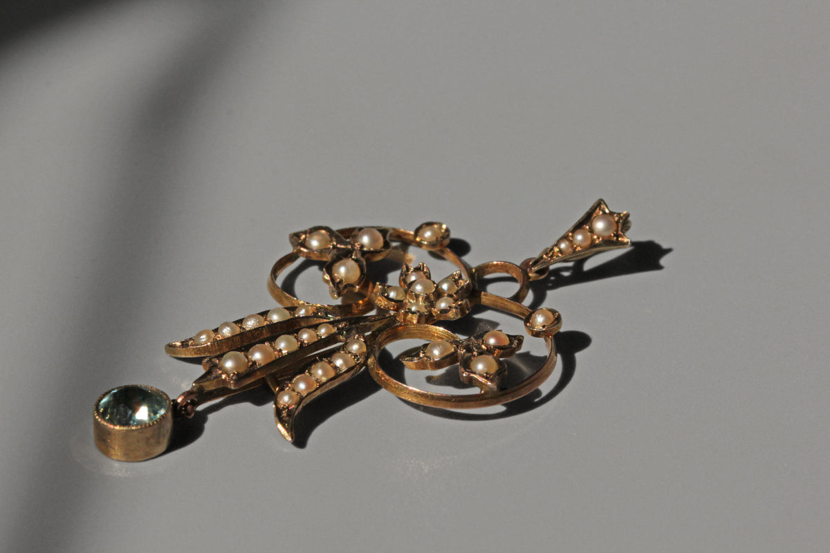 Antique Victorian seed pearl and aquamarine pendant in 9 carat gold side profile