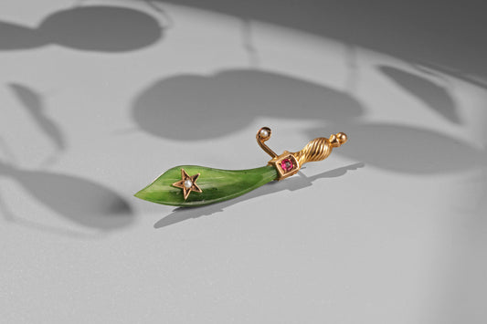 Victorian curved jade dagger brooch with ruby gemstone and pearl star motif
