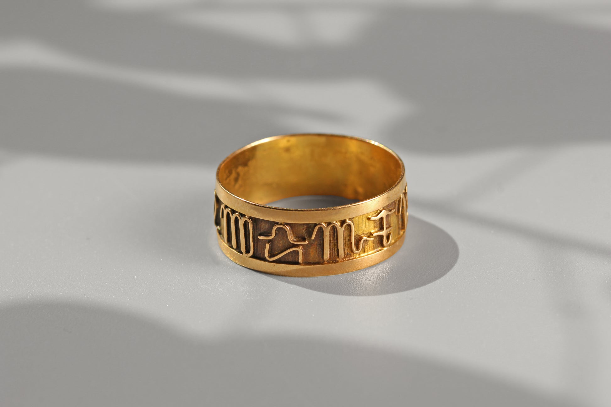 Wide vintage 18ct gold band ring with celestial zodiac symbols
