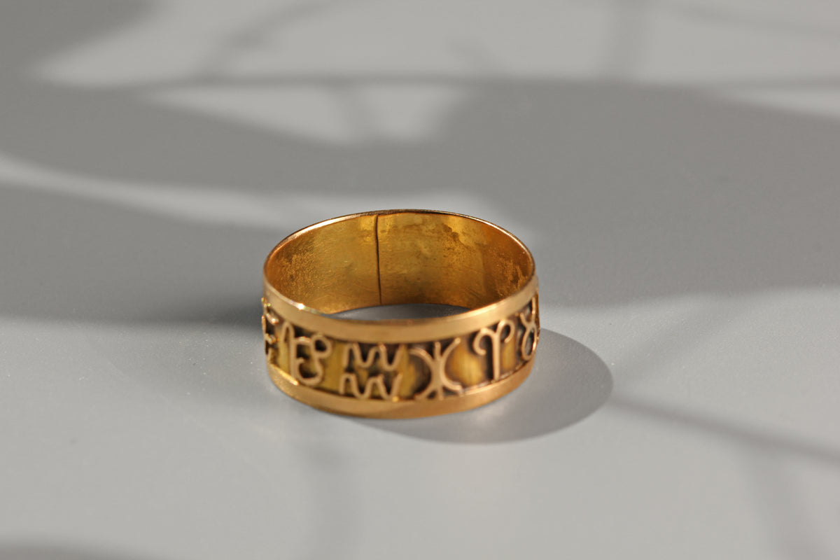 Openwork 18 carat gold horoscope ring with graphic symbol detailing
