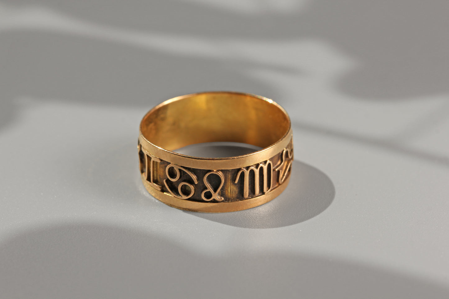 Detailed view of vintage zodiac symbol ring in 18ct gold
