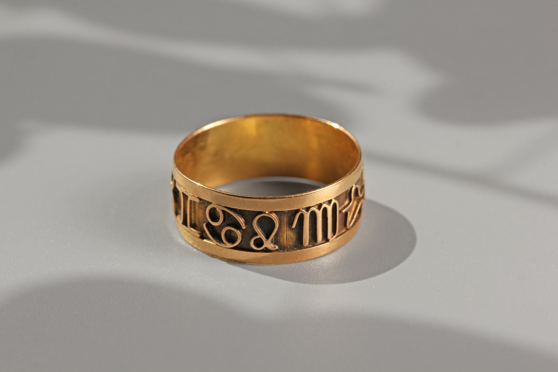 Detailed view of vintage zodiac symbol ring in 18ct gold

