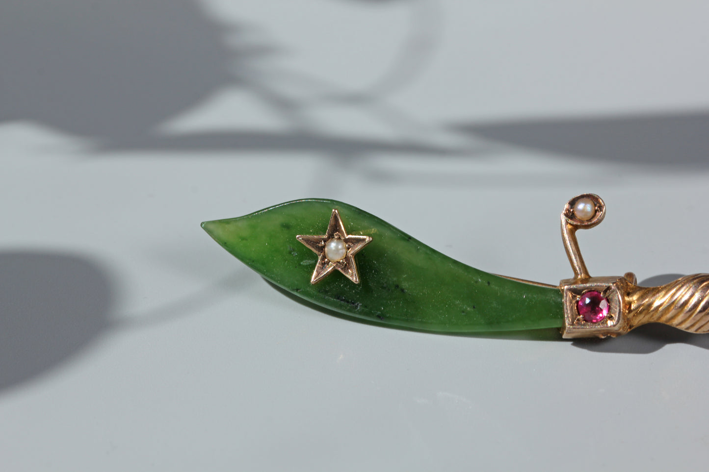 Close up of Victorian ruby set scimitar hilt in warm 9ct gold
