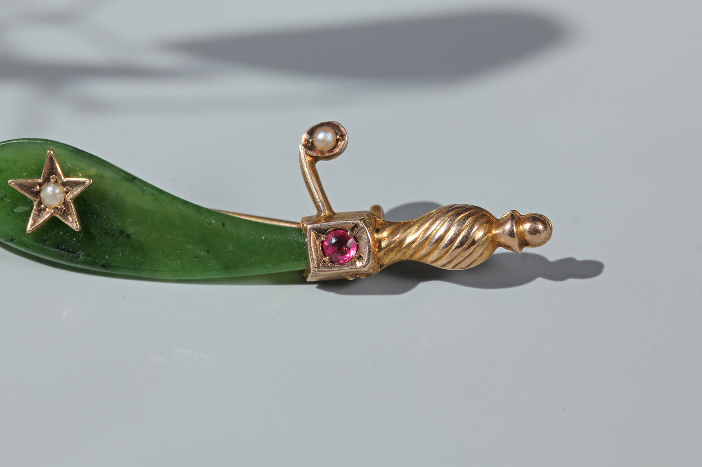 Antique curved nephrite jade brooch with pearl set star decoration
