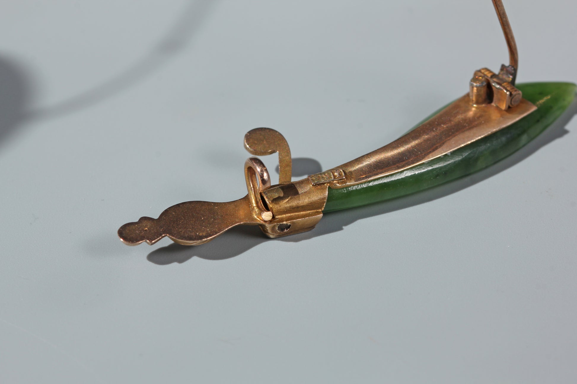 Antique Victorian jade dagger brooch photographed in natural sunlight