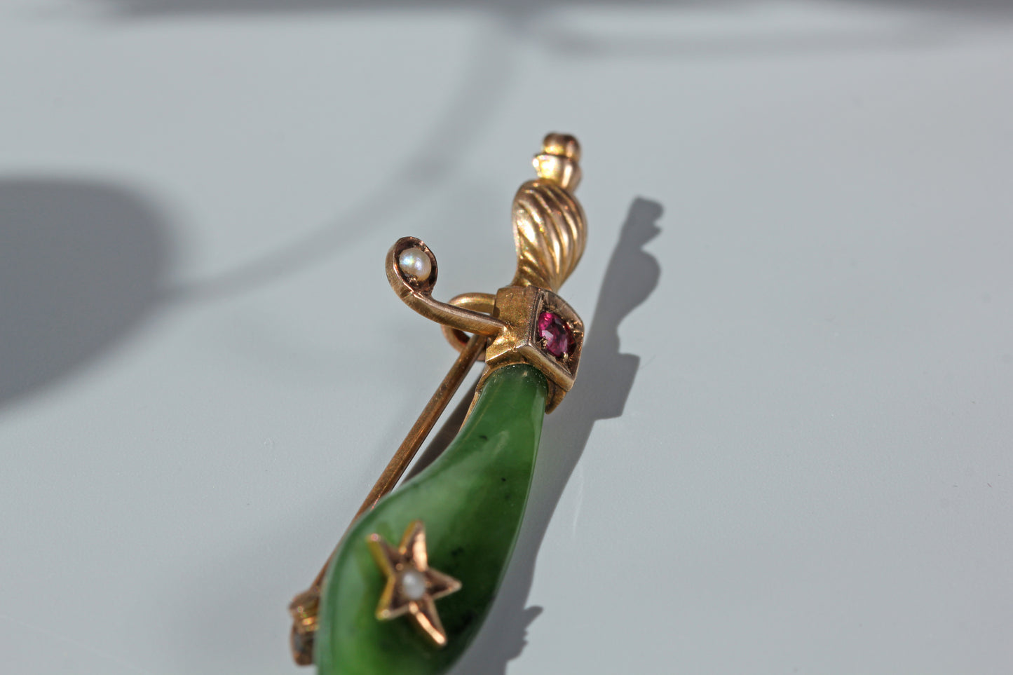 Antique nephrite, ruby & pearl scimitar brooch, in 9 carat gold