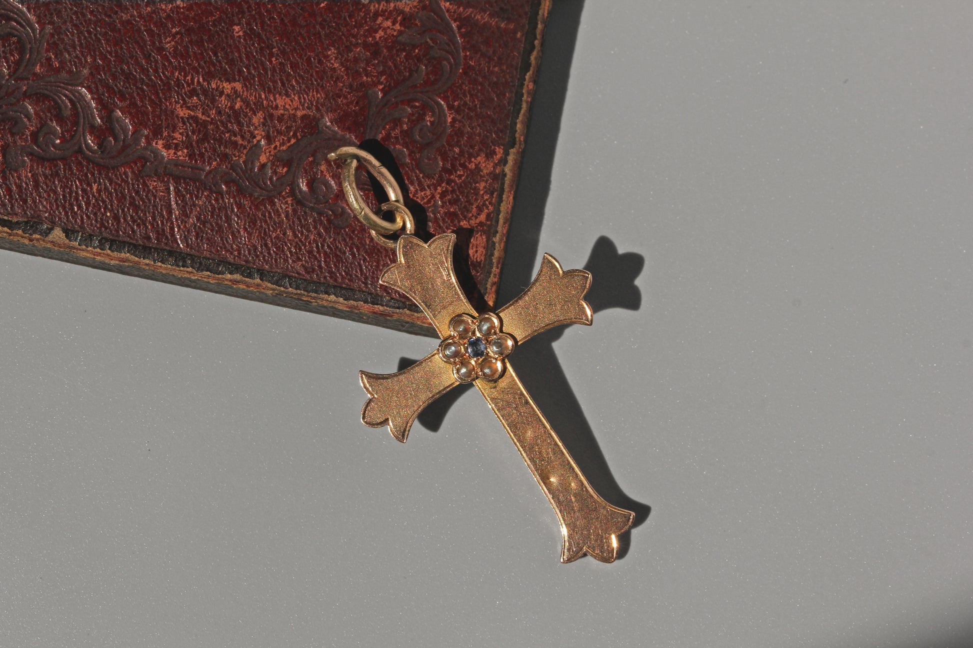 Antique victorian gold crucifix pendant with pearls and sapphire on antique box
