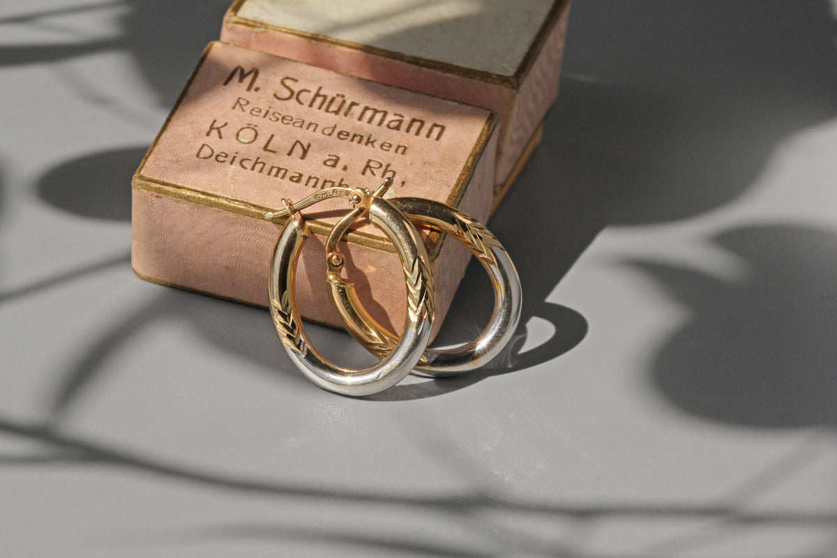 Pair of white and yellow gold hoop earrings with German ring box