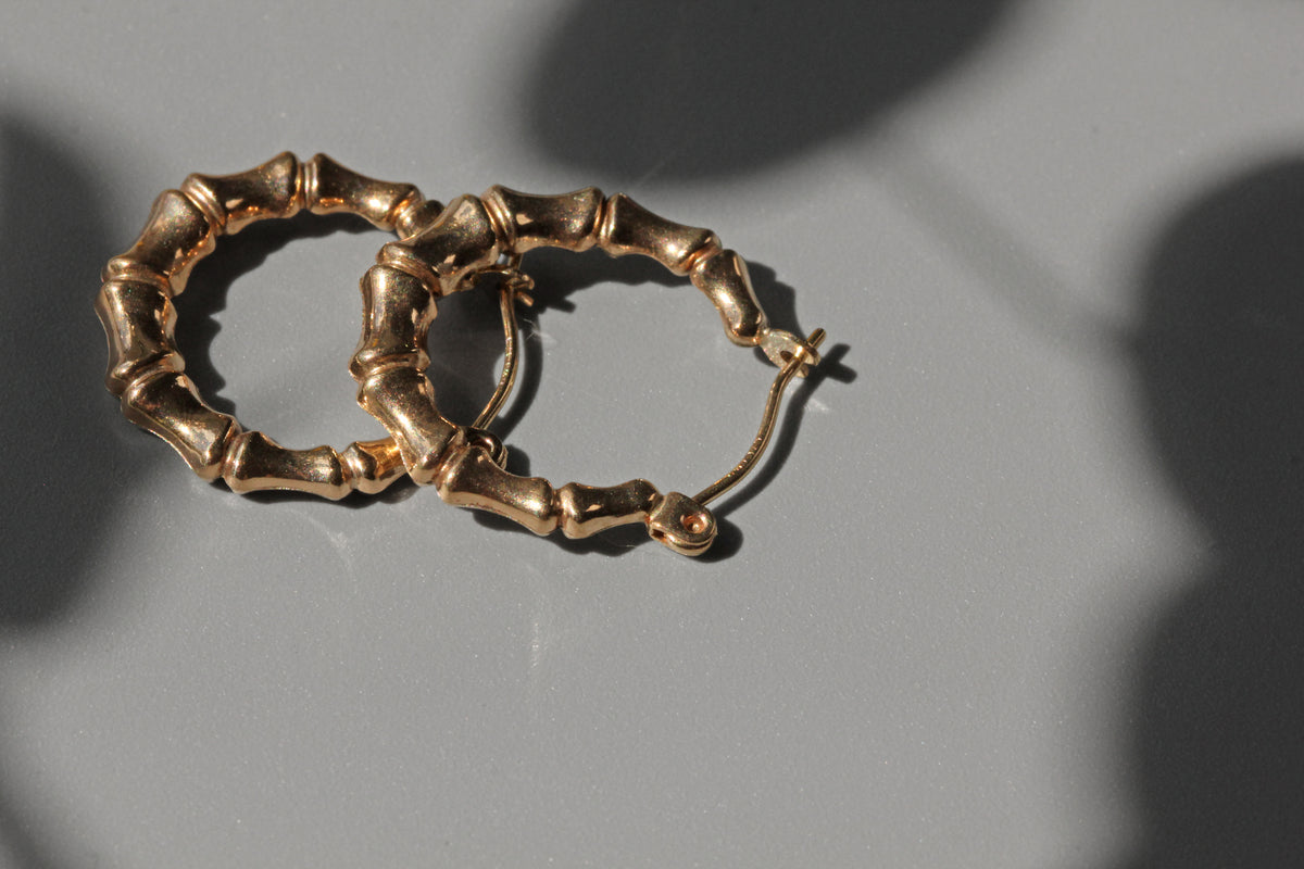Side view of vintage bamboo hoop earrings in 9 carat gold
