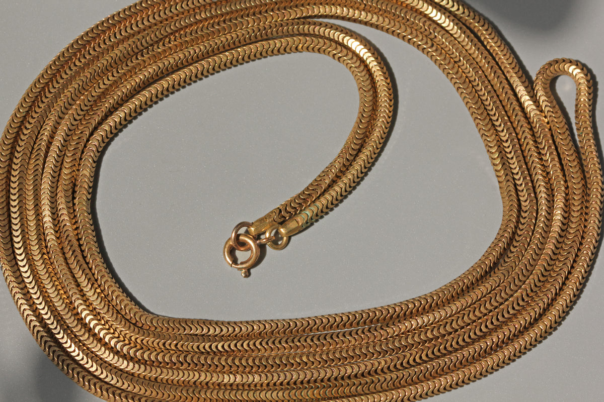 Antique snake link 70-inch necklace chain in gold pinchbeck close up