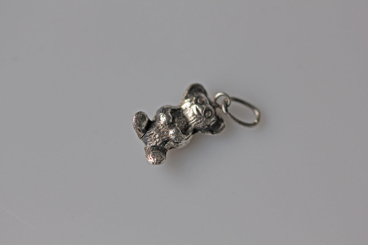 Vintage novelty silver charm depicting a teddy bear figure