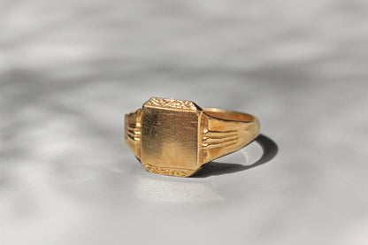 Close up of blank signet face with foliate scroll detail
