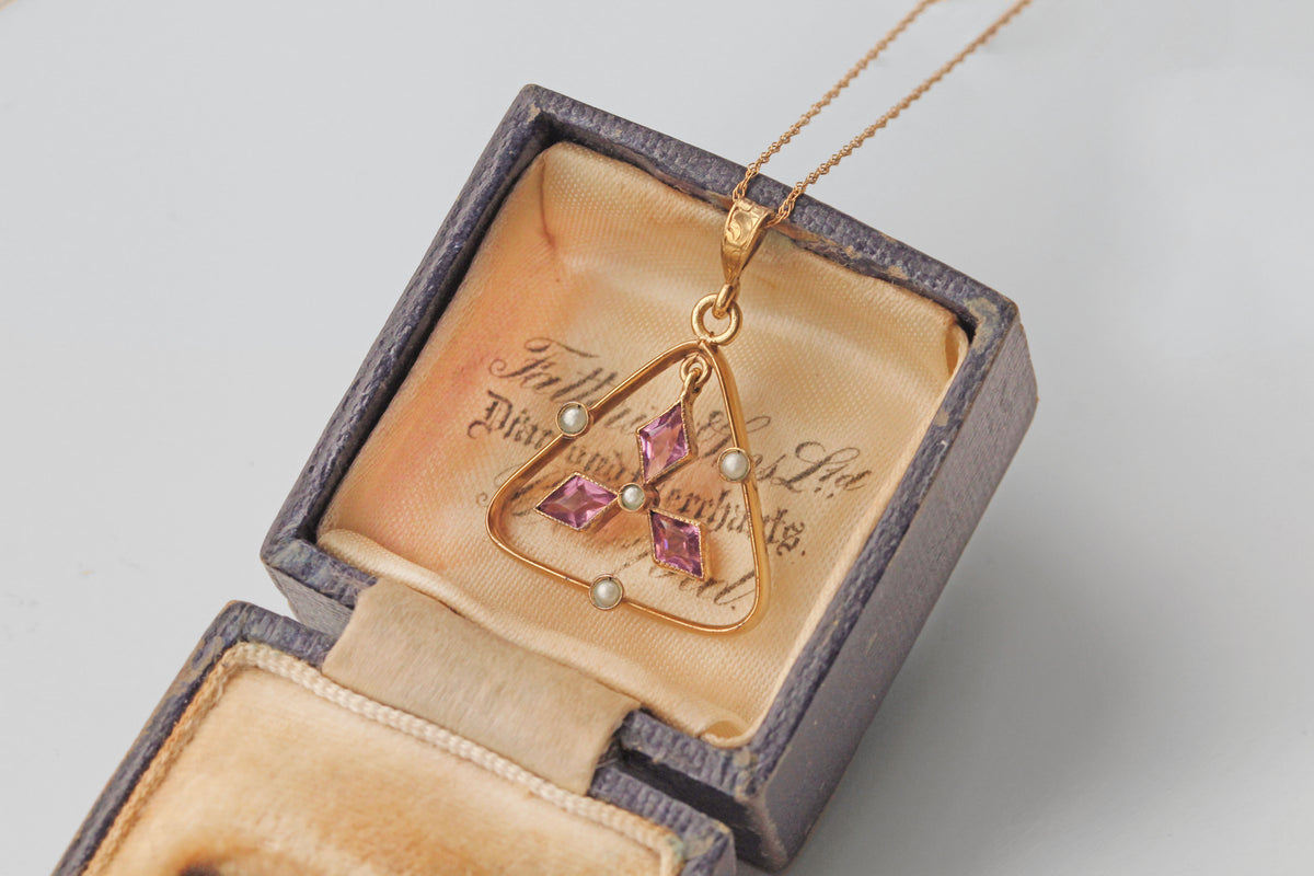 Edwardian rolled gold pendant with floral star motif
