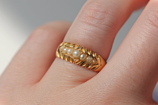 Victorian antique pearl band ring in 18ct gold on the finger