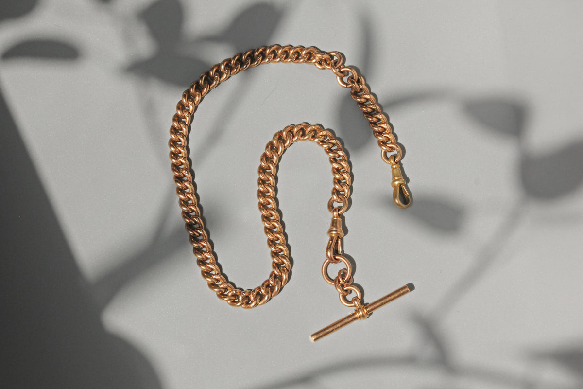 Antique curb link Albert chain with T-bar and dog clips in 9 carat gold