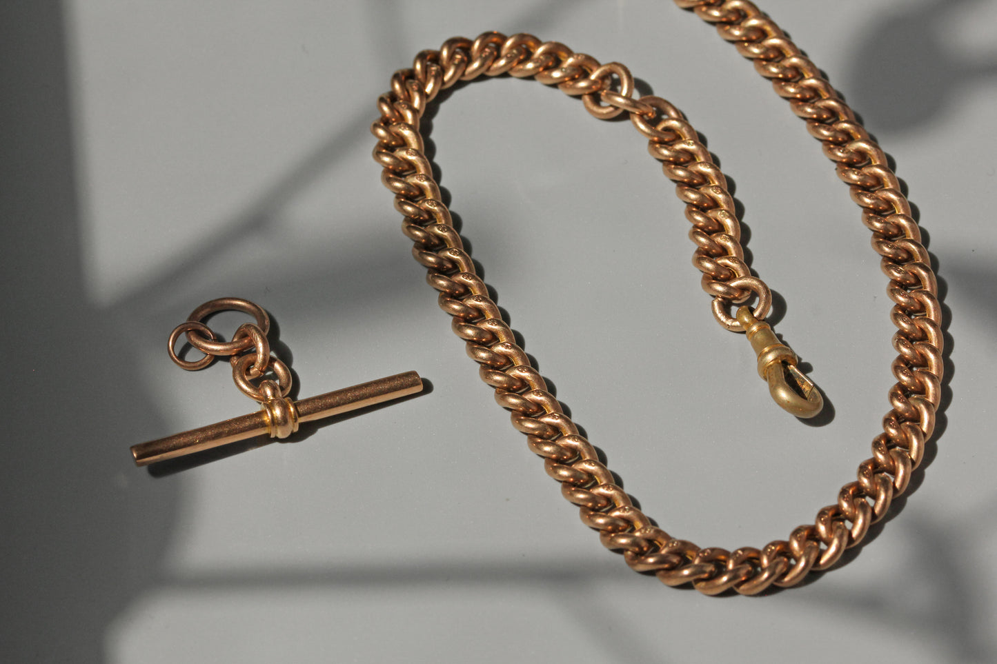 Antique curb link albert chain with tbar, in 9 carat gold