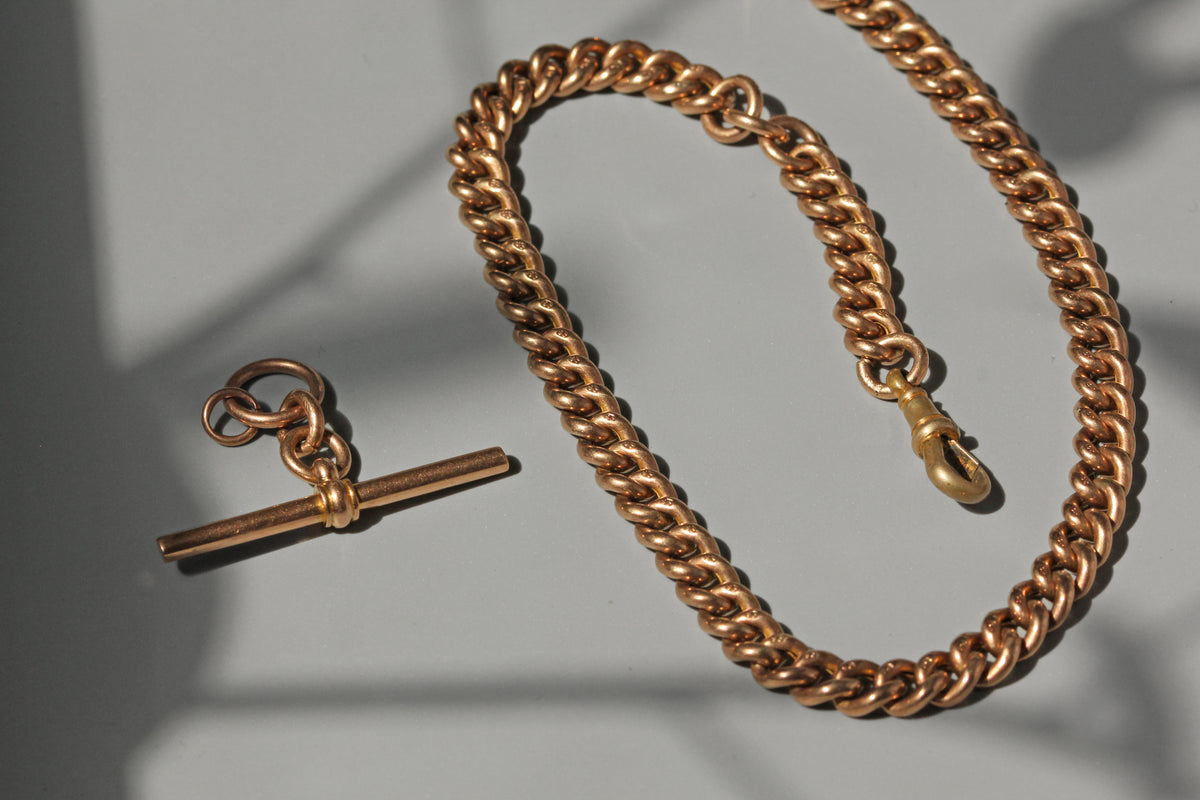 Antique curb link Albert chain with T-bar in 9 carat gold close up