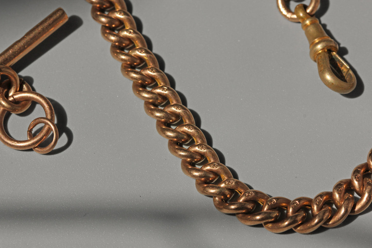 Antique curb link albert chain with tbar, in 9 carat gold