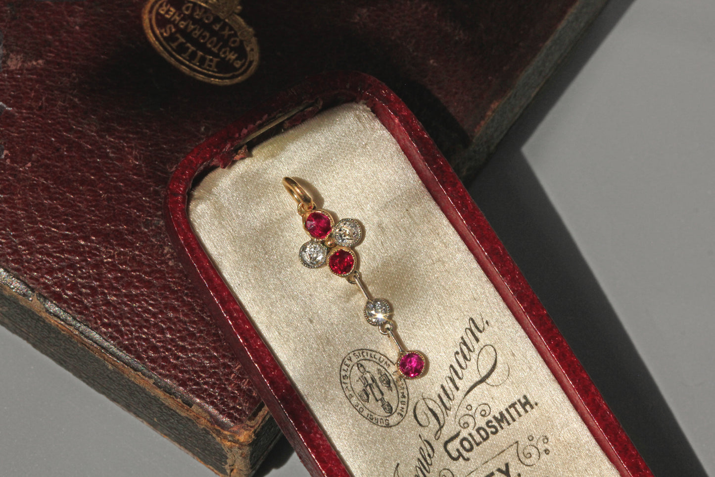 Antique art deco old cut diamond and ruby pendant, in 9 carat gold