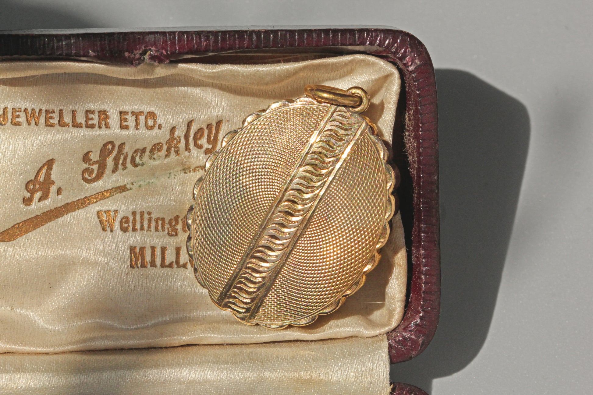 Close up of engine turned Victorian belt buckle locket