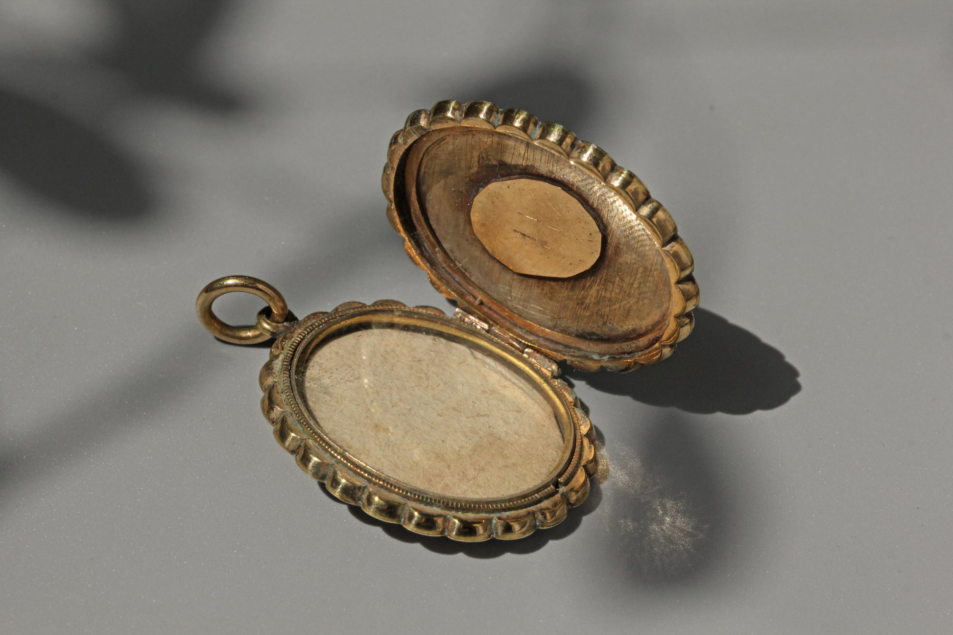 Open view of antique Victorian belt buckle locket with photo frame