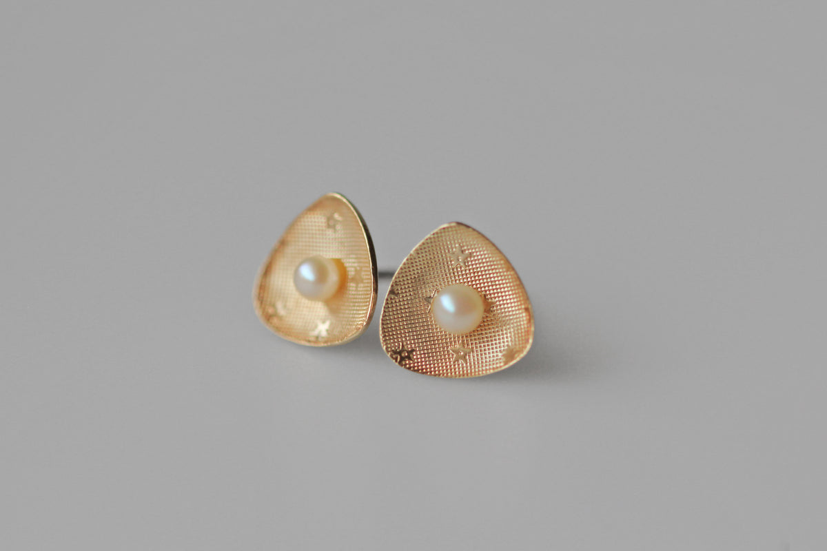 Vintage Akoya pearl celestial star earrings in 9 carat gold in soft lighting